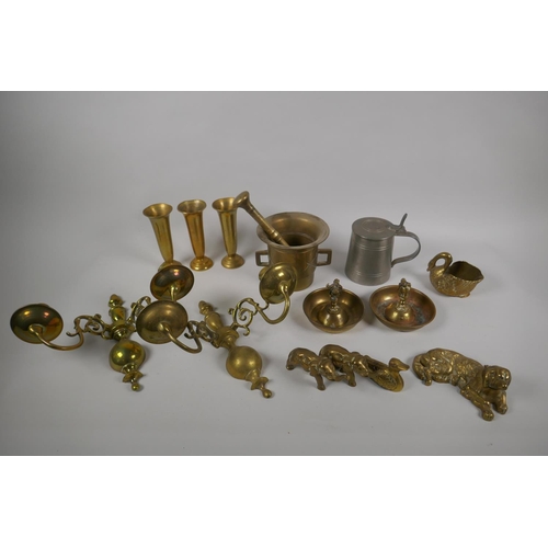 161 - A quantity of antique brass ware to include a pestle and mortar, a pair of two branch candle sconces... 