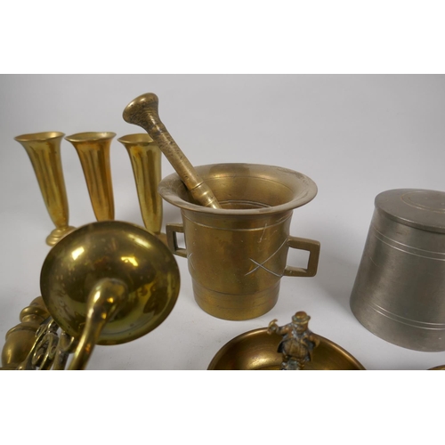 161 - A quantity of antique brass ware to include a pestle and mortar, a pair of two branch candle sconces... 