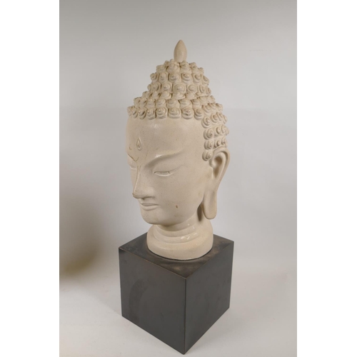 17 - A decorative ceramic Buddha head by Austin Productions, 1961, 51cm high, and a decorative gilt leaf ... 