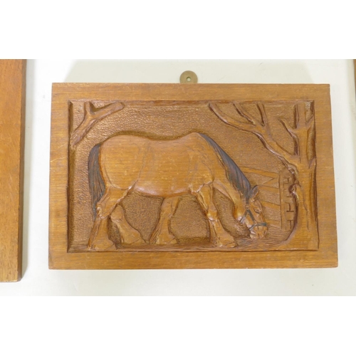 172 - A pair of oak panels carved in low relief with horse's heads, and another of a horse feeding under a... 