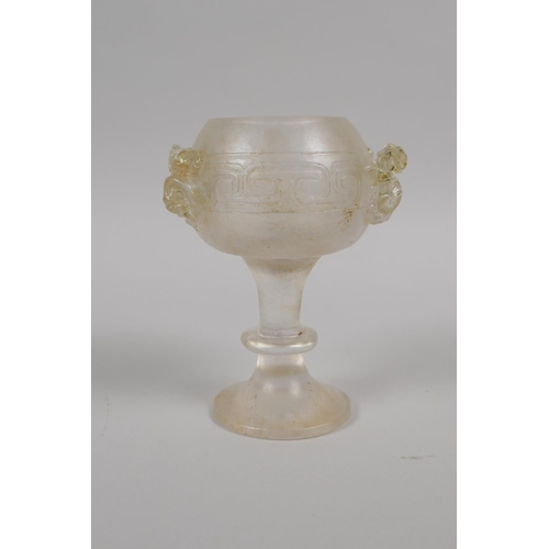 175 - A Chinese molded glass libation cup with twin dragon handles, 11cm high