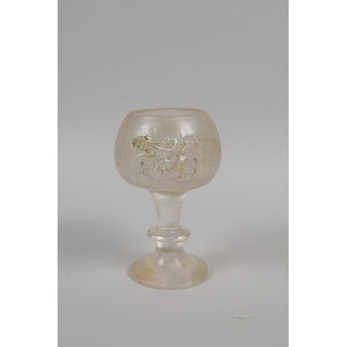 175 - A Chinese molded glass libation cup with twin dragon handles, 11cm high