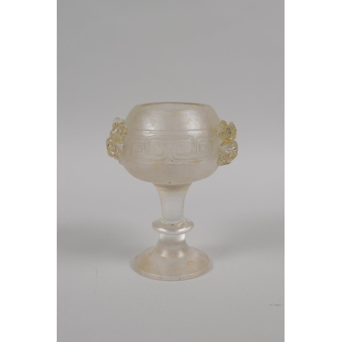 175 - A Chinese molded glass libation cup with twin dragon handles, 11cm high