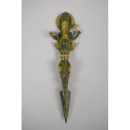 176 - A Tibetan bronze ceremonial phurba with gilt highlights and ganesh shaped handle, 32cm long