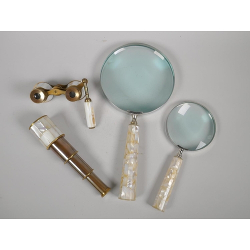 182 - Two mother of pearl handled magnifying glasses, a pair of mother of pearl and brass opera glasses, a... 