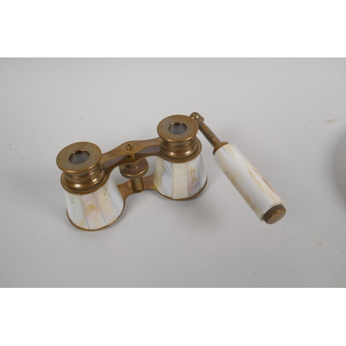 182 - Two mother of pearl handled magnifying glasses, a pair of mother of pearl and brass opera glasses, a... 