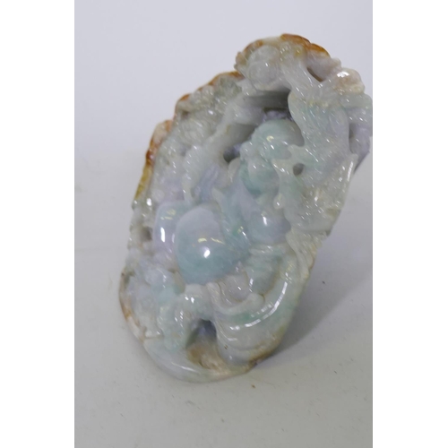 184 - A Chinese carved hardstone ornament depicting a jolly Buddha bearing a lotus, 13cm high