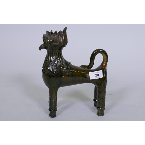 20 - A slip glazed terracotta figure of a lion in the canakkale style, signed to base, 25cm high