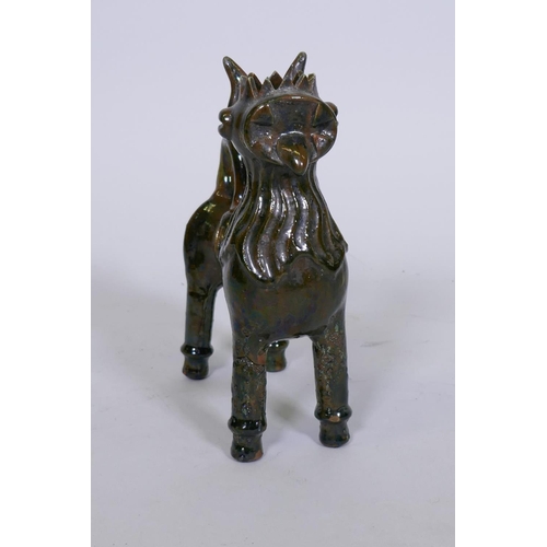 20 - A slip glazed terracotta figure of a lion in the canakkale style, signed to base, 25cm high