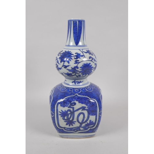 215 - A Chinese blue and white porcelain double gourd vase with stylised inscription decoration, Jiajing 6... 