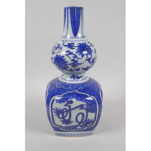 215 - A Chinese blue and white porcelain double gourd vase with stylised inscription decoration, Jiajing 6... 