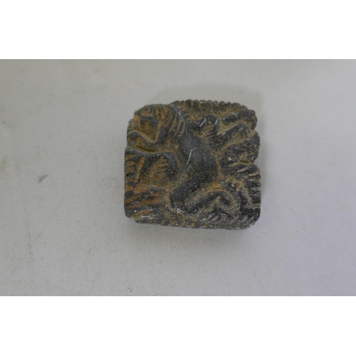 219 - A stone pendant amulet carved with a lion, 3 x 3cm