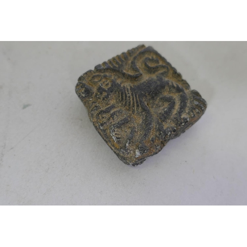 219 - A stone pendant amulet carved with a lion, 3 x 3cm