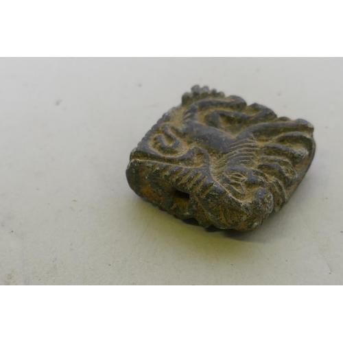 219 - A stone pendant amulet carved with a lion, 3 x 3cm