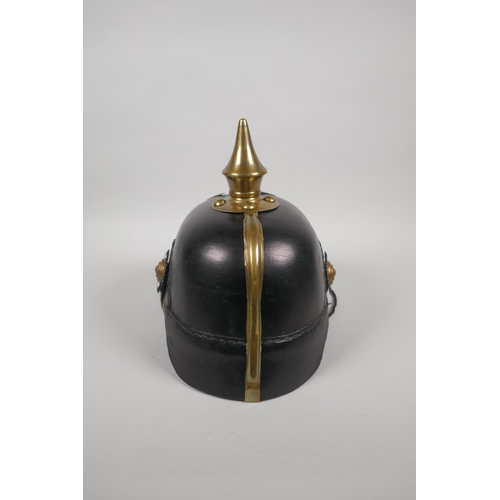 223 - A reproduction German pickelhaube with brass mounts