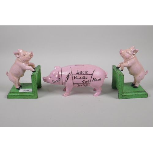 228 - A pair of painted cast iron pig bookends, 14cm high, and a painted cast iron pig money box