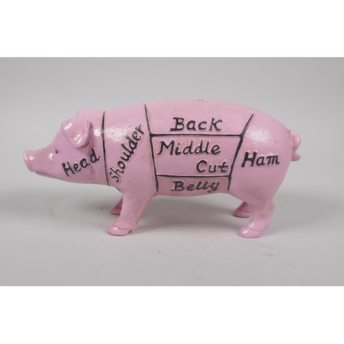 228 - A pair of painted cast iron pig bookends, 14cm high, and a painted cast iron pig money box