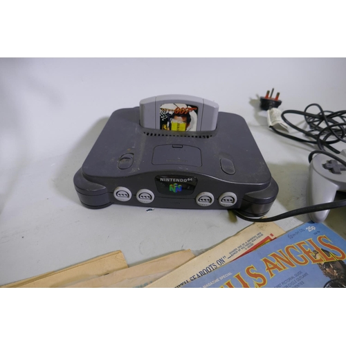 232 - A Nintendo 64 control deck and controller, Action Man and children's annual and comics