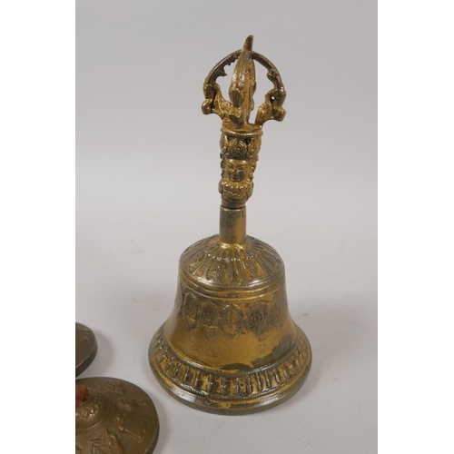 240 - A Tibetan gilt metal ceremonial bell with a vajra handle and a pair of ceremonial cymbals, 16cm