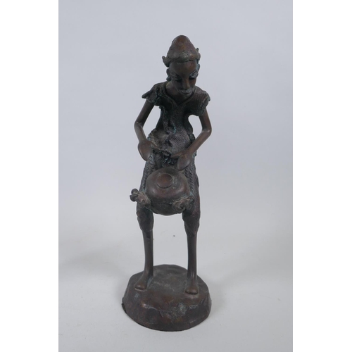 247 - Three African Burkina Faso bronze figures of a traveller, drum player and dancer, largest 33cm high