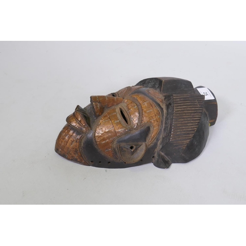 25 - African Gabon Punu carved wood and copper sheathed mask, 33cm long