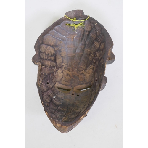 25 - African Gabon Punu carved wood and copper sheathed mask, 33cm long