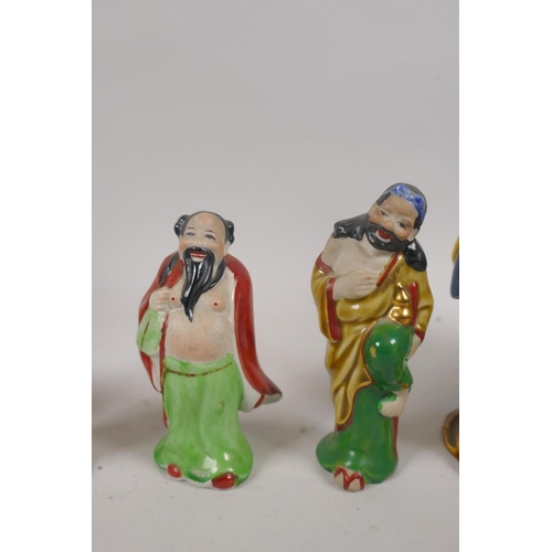 250 - Eight oriental ceramic figures of bearded sages, largest 20cm high, AF