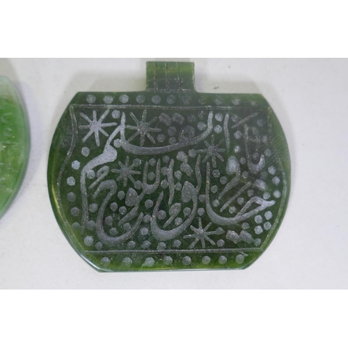 256 - Two jade pendants carved with Islamic calligraphy, 6cm wide