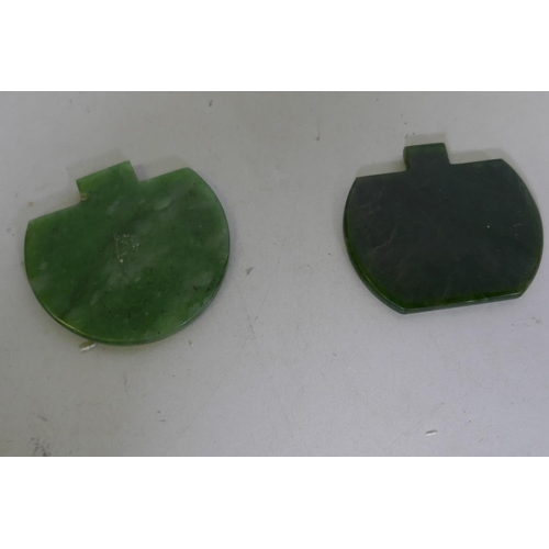 256 - Two jade pendants carved with Islamic calligraphy, 6cm wide