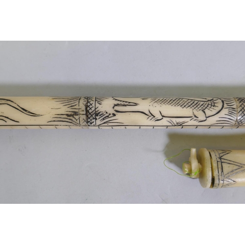 26 - An imitation bone Sumatran style blow gun with carved decoration, 120cm long