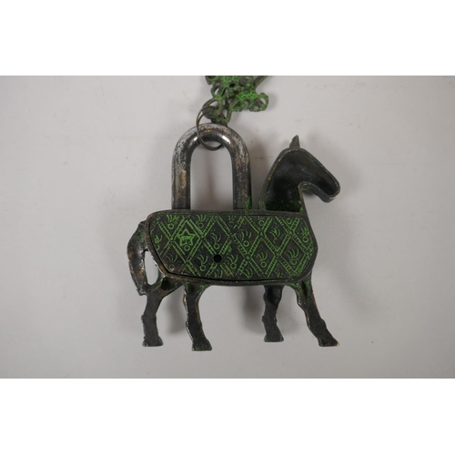 260 - A Tibetan metal horse padlock with verdigris patina, 14cm long