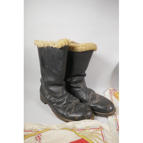 34 - A WWII British civil defence helmet, a pair of WWII sheep skin lined leather pilot's boots and a pai... 