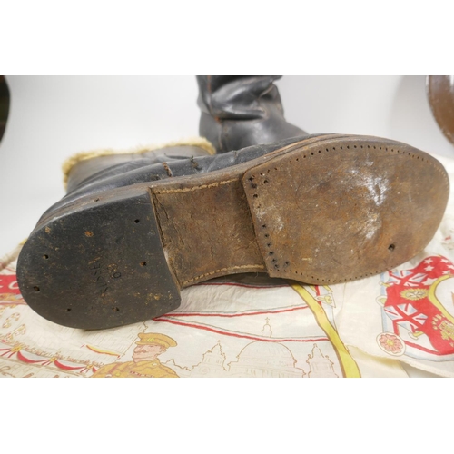 34 - A WWII British civil defence helmet, a pair of WWII sheep skin lined leather pilot's boots and a pai... 