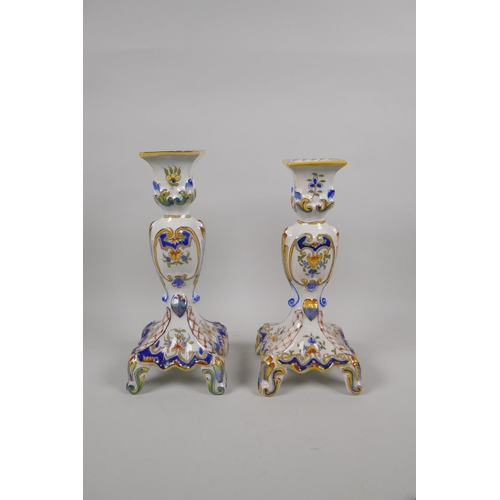 36 - A pair of antique French Faience Quimper pottery candlesticks, and a similar twin section desk stand... 