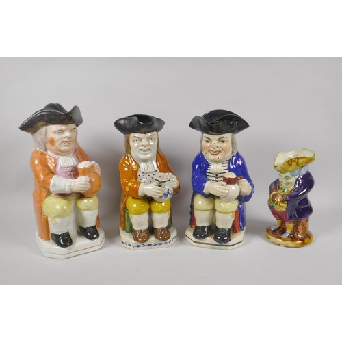 39 - Two late C18th/early C19th pearlware toby jugs in the form of seated figures holding jugs of ale (on... 