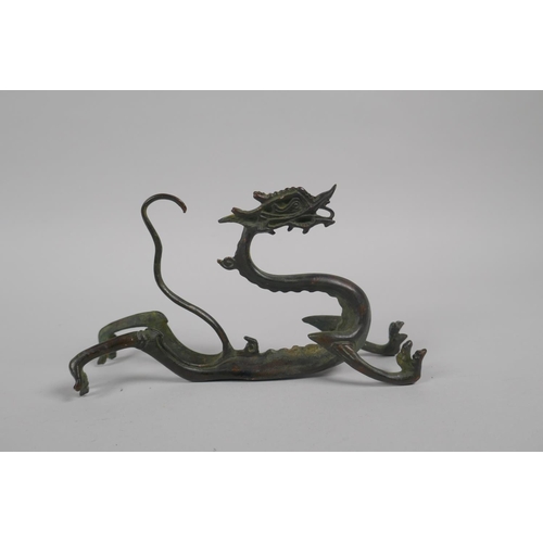 41 - A Chinese bronze brush rest in the form of a dragon, 15cm long