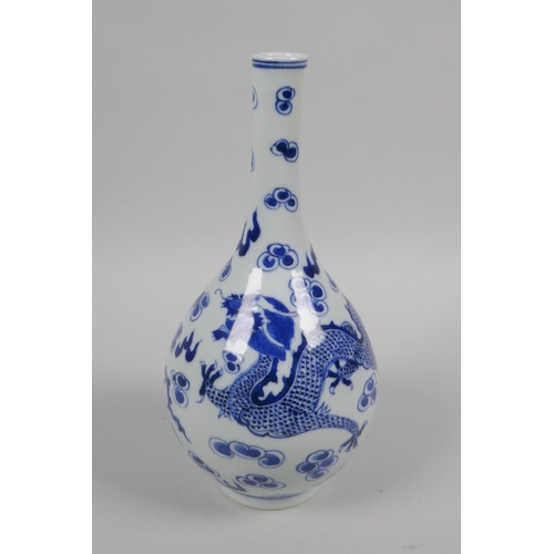 42 - An early C20th Chinese blue and white porcelain bottle vase decorated with a dragon and phoenix, 22c... 