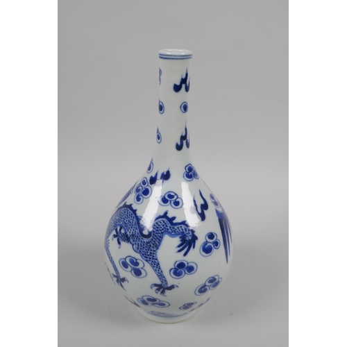 42 - An early C20th Chinese blue and white porcelain bottle vase decorated with a dragon and phoenix, 22c... 