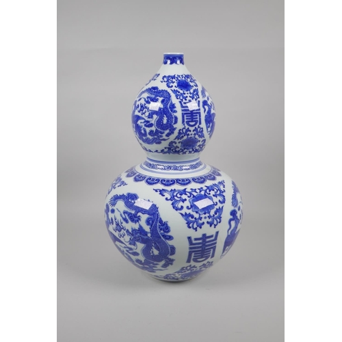 48 - A Chinese blue and white porcelain double gourd vase, decorated with dragons, phoenix, flowers and a... 