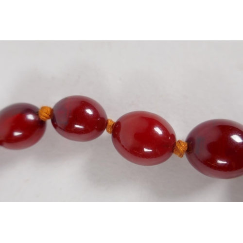 605 - A graduated honey amber bead necklace with 9ct gold clasp, 40cm long, 50g