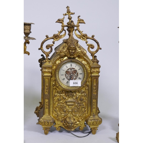 606 - A C19th gilt brass clock garniture, the clock with electric movement flanked by a pair of four branc... 