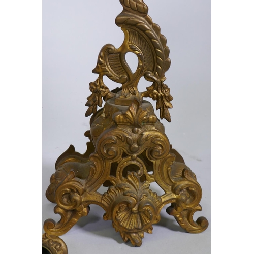 606 - A C19th gilt brass clock garniture, the clock with electric movement flanked by a pair of four branc... 