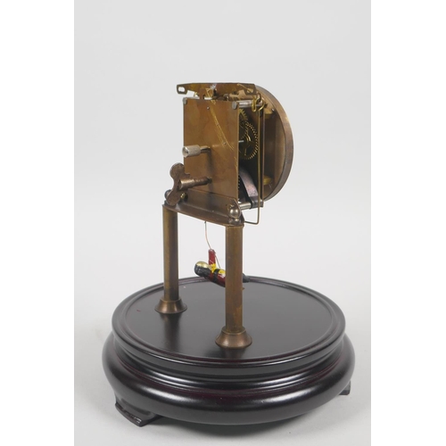 609 - A glass domed skeleton clock, the pendulum in the form of a child on a swing, 21cm high