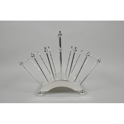 612 - A Christopher Dresser style silver plated toast/letter rack, 22cm long