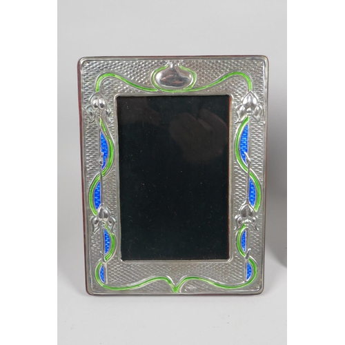 620 - A pair of sterling silver and enamel Art Nouveau style photo frames, aperture 9 x 13cm