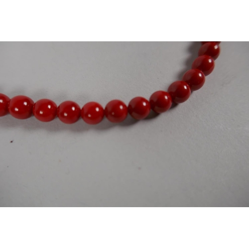 629 - A coral beaded necklace, 80cm long