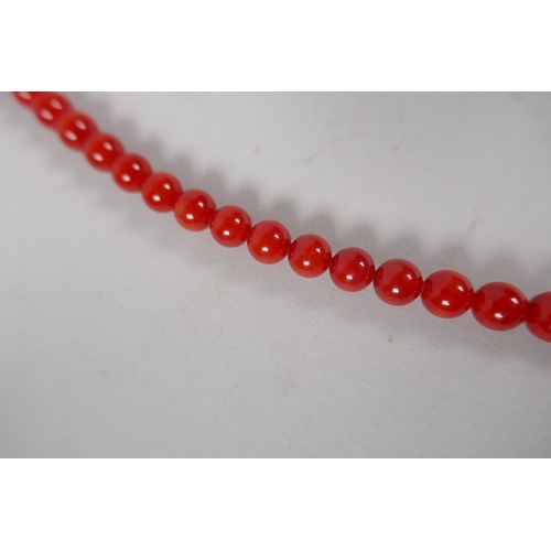 629 - A coral beaded necklace, 80cm long