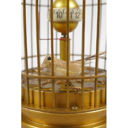 630 - A brass bird cage automaton clock, 14cm high