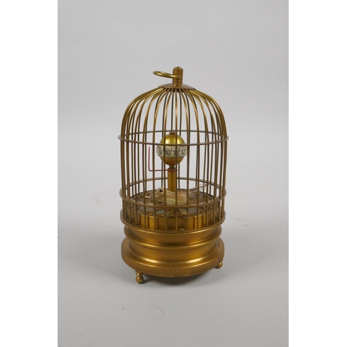 630 - A brass bird cage automaton clock, 14cm high