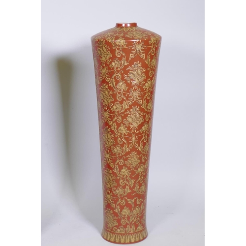 64 - A pair of oriental ceramic floor vases with raised decoration on a red glaze, 63cm high